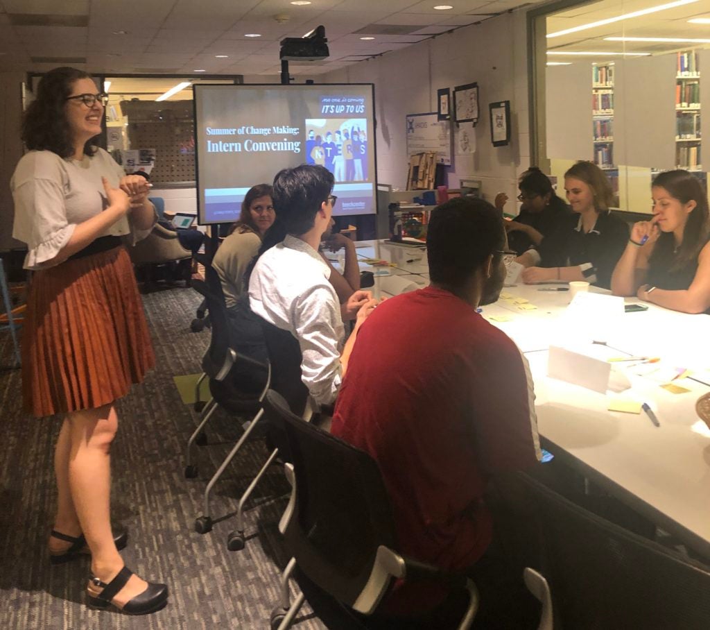 students talking around a conference table