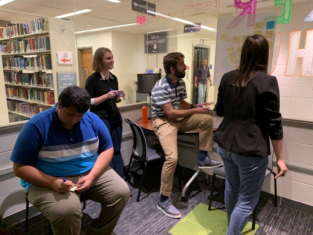 students writing sticky notes