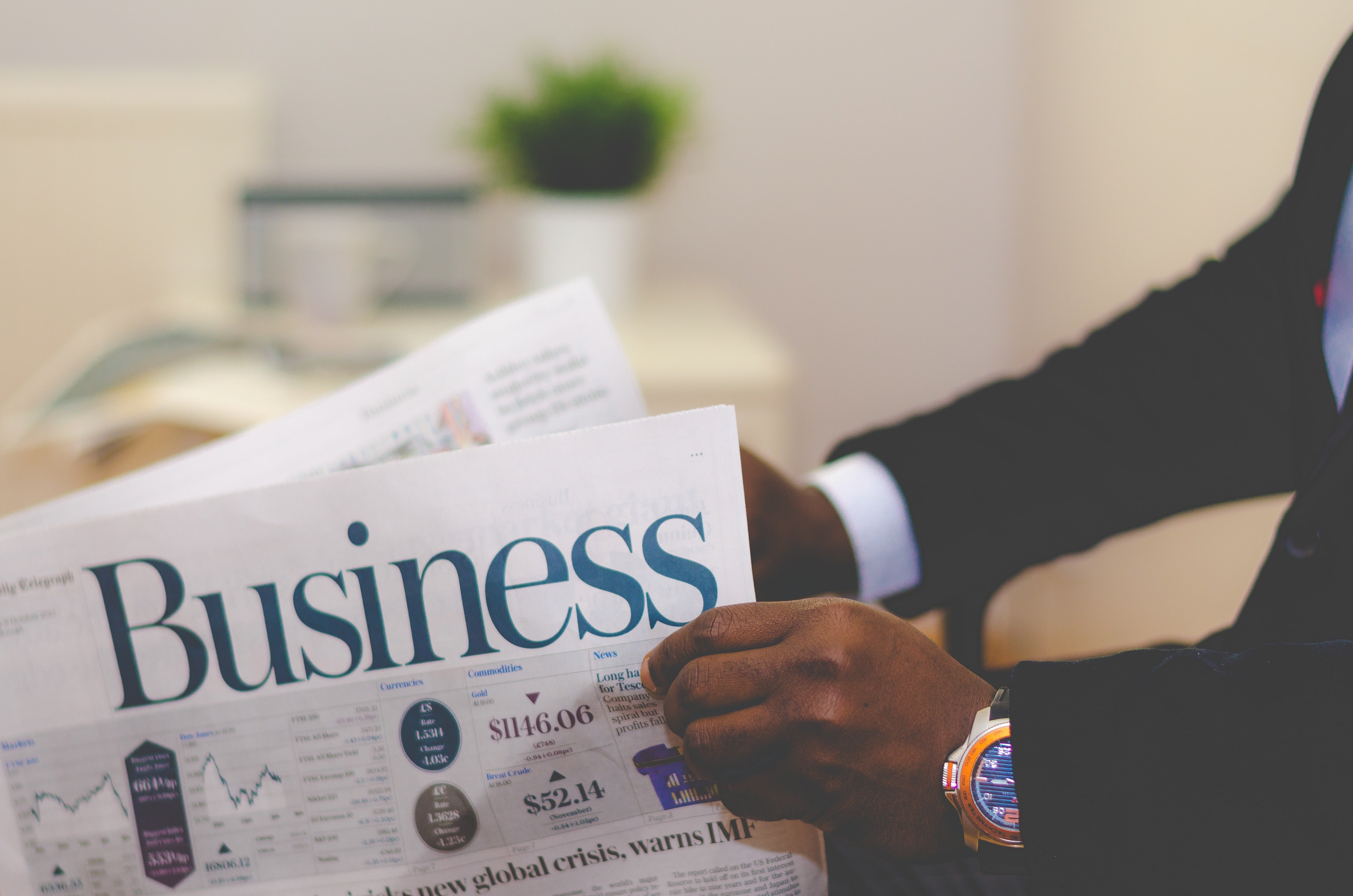 man reading business newspaper