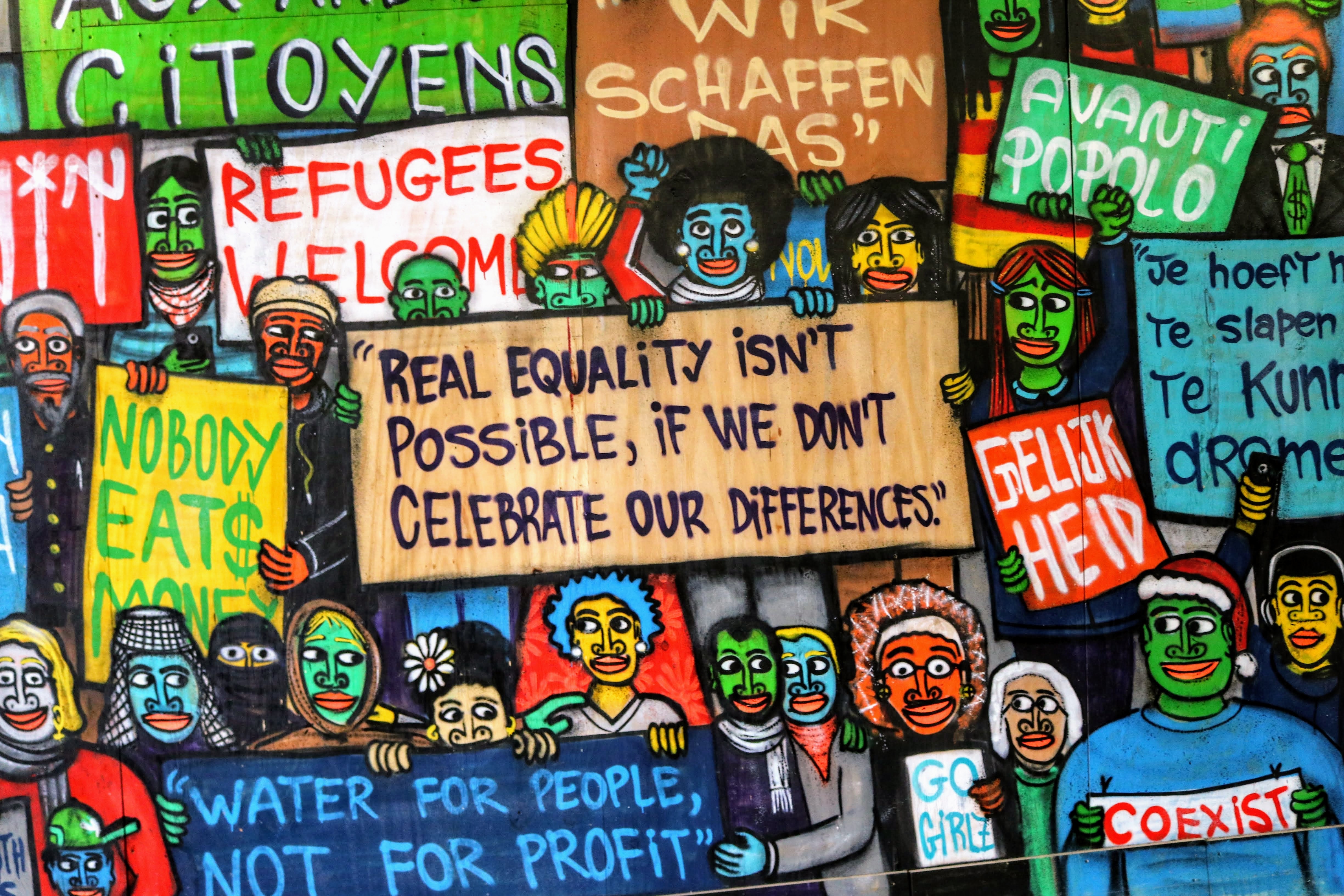 Colorful grafitti saying "Real equality isn't possible if we don't celebrate our differences