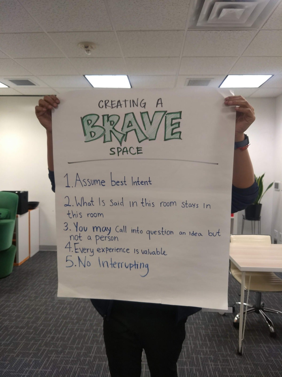 Student holding sign of ground rules for discussion