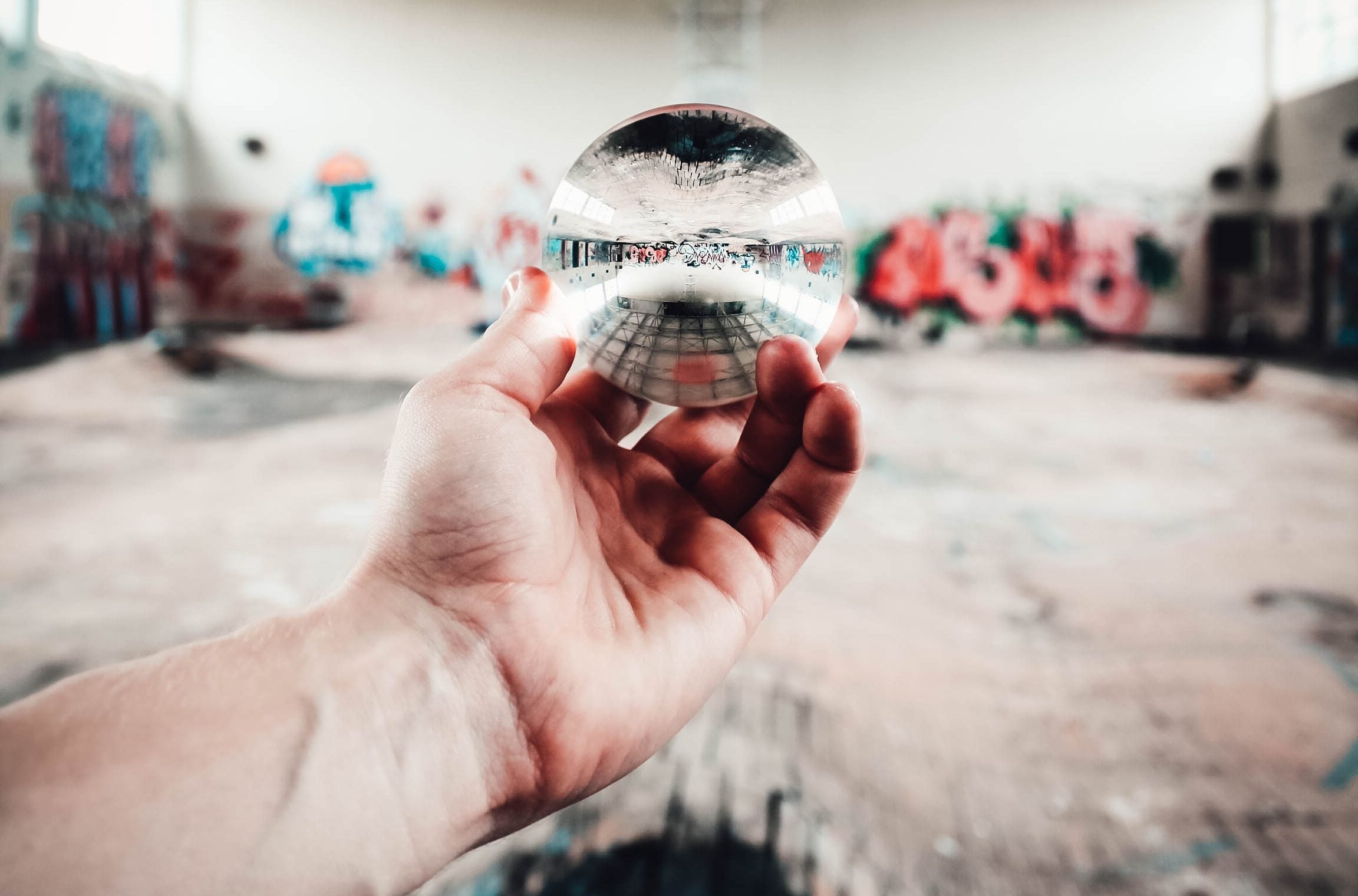 person holding clear glass ball