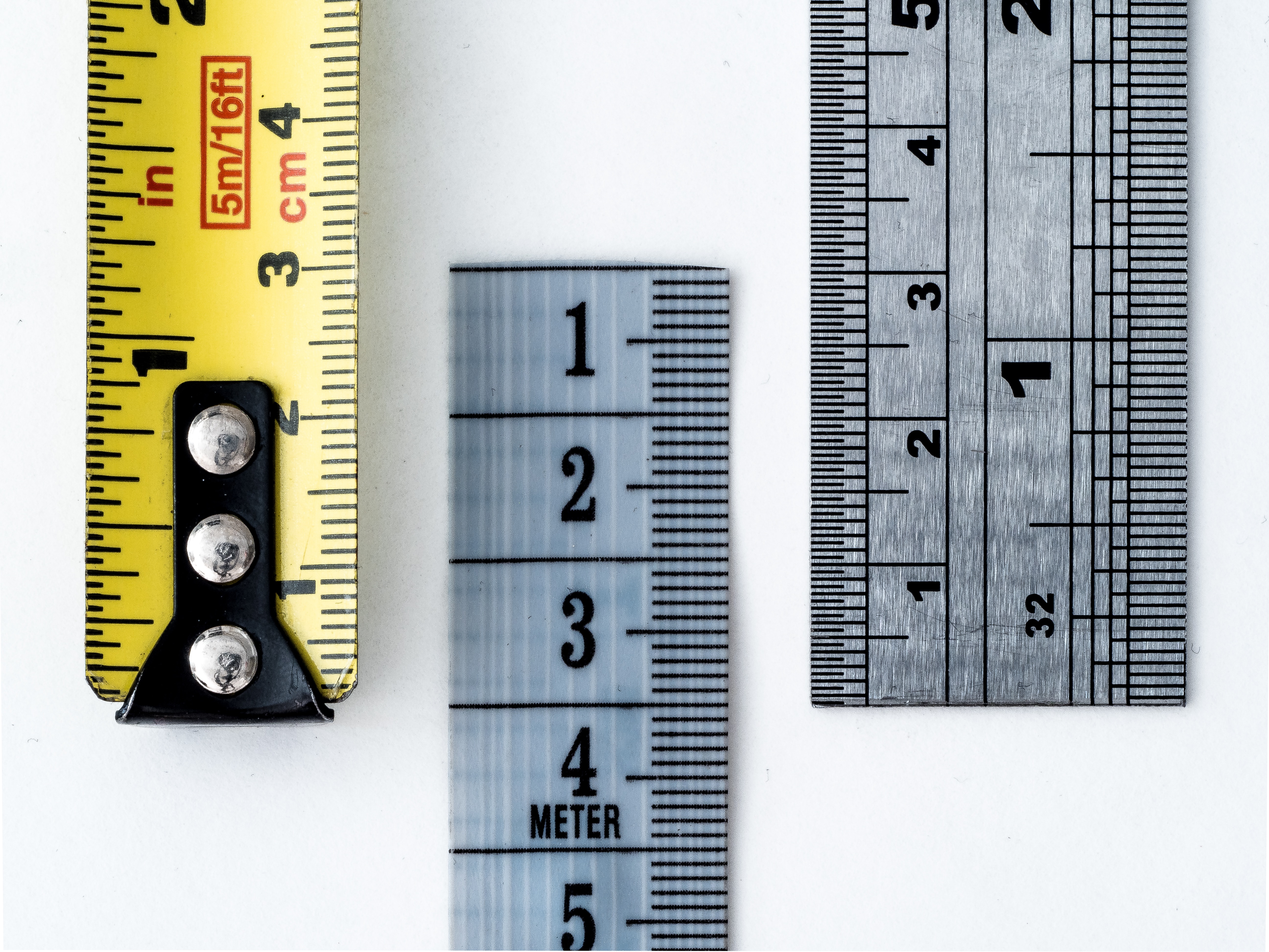 gray and yellow tape measures and rulers