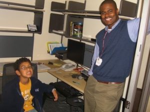 young boy and man standing in office