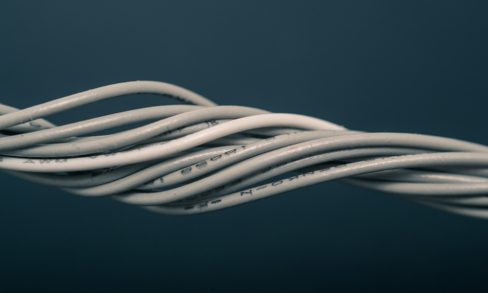 bundle of white wires on gray background