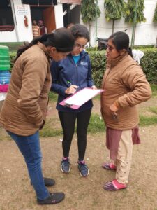 three women looking at a clipboard