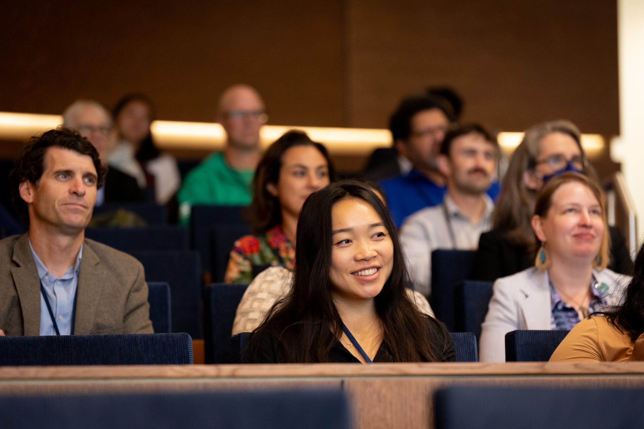 Woman smiling in crowd at BenCon