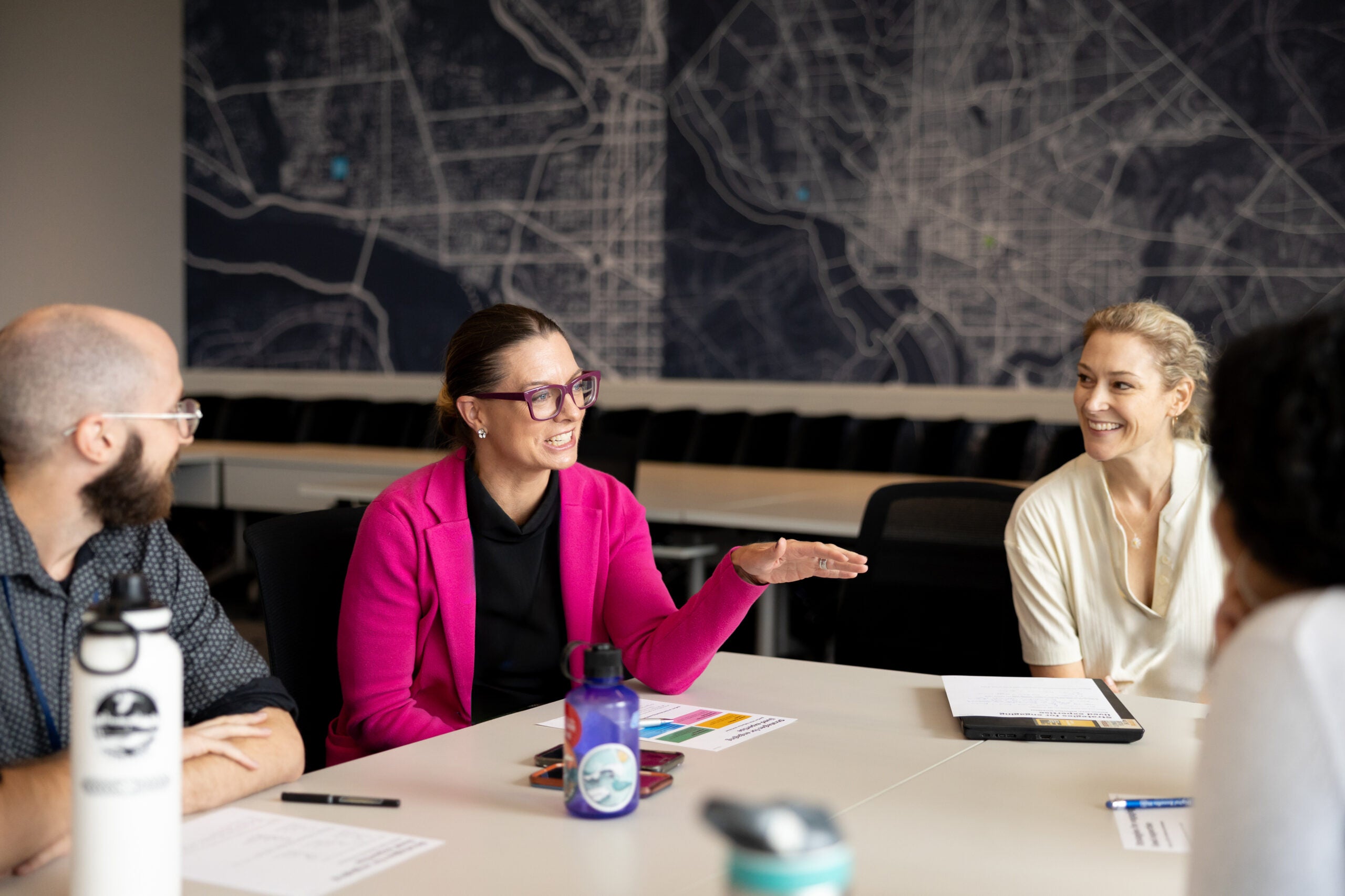 Women working together, talking around at table