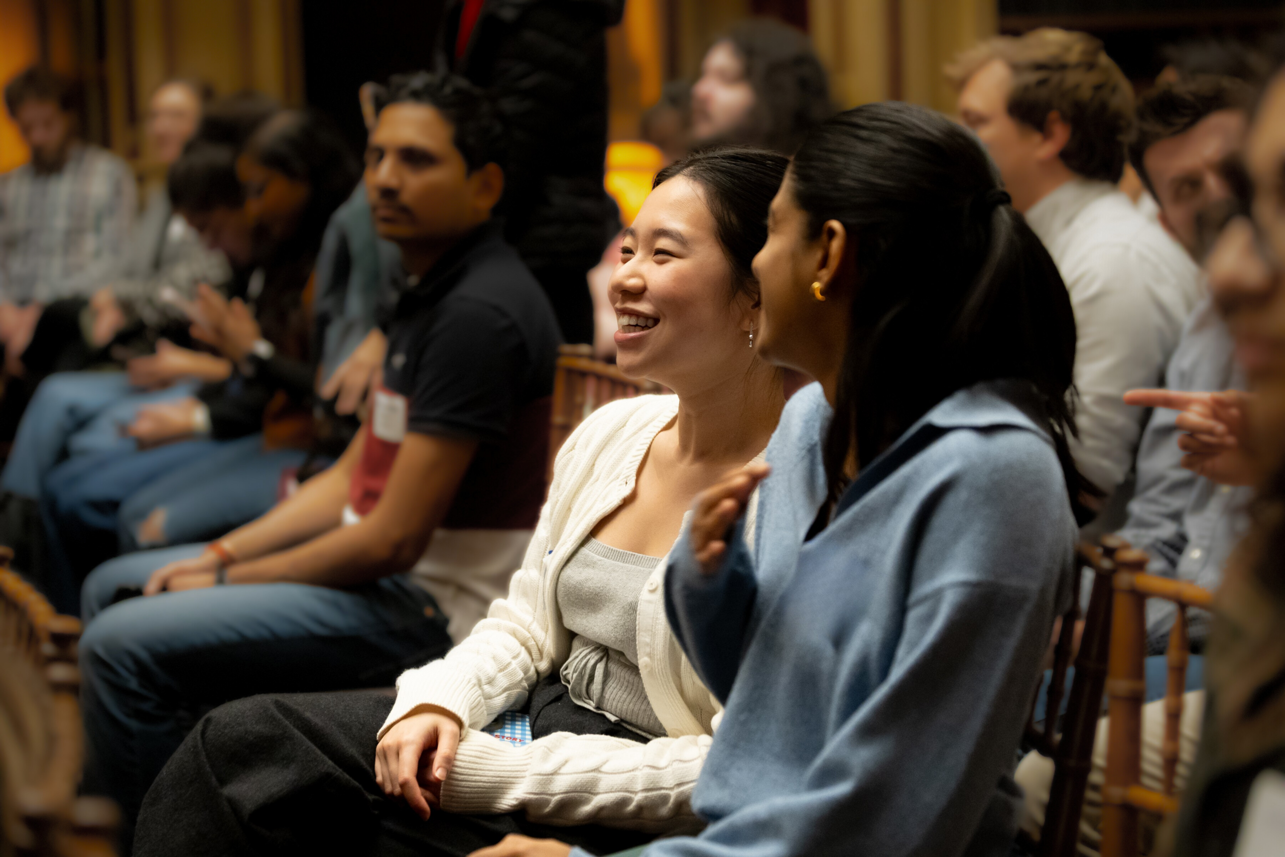 Two students talk with each other during the Beeck Center's Civic Tech Live event, discussing insights from the panel's conversation on the evolution of data science and AI in civic tech.